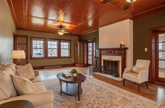 a view of a livingroom with a fireplace and window
