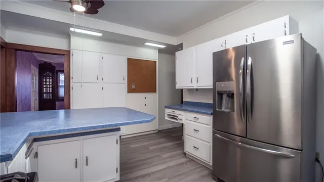a kitchen with refrigerator and cabinets