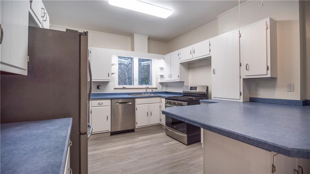 343 East 11th Avenue Tarentum, PA 15084 - Photo 26 of 41 a kitchen with stainless steel appliances a sink stove and refrigerator