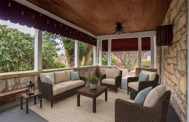 a view of backyard with large trees and plants