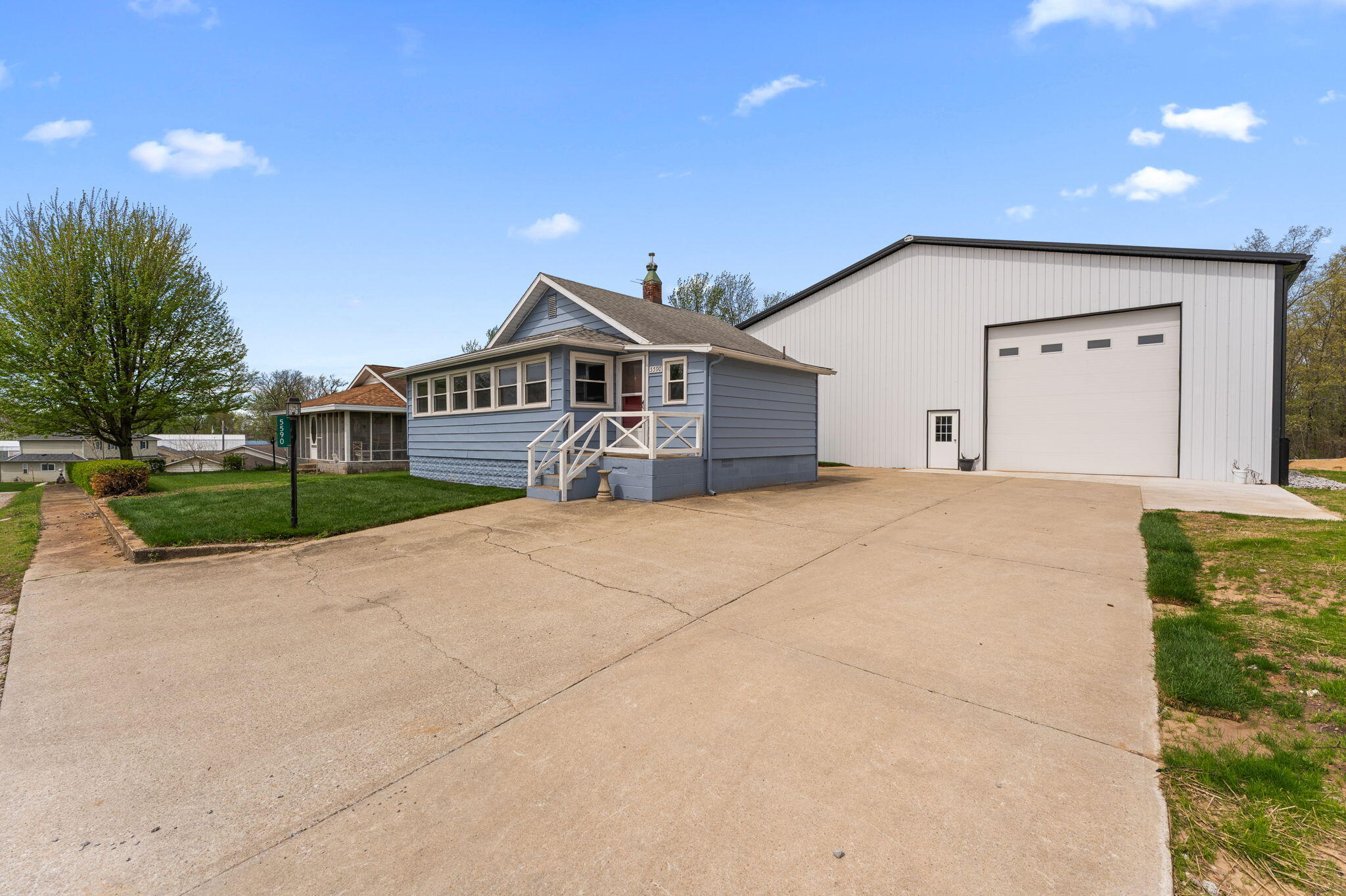 5590 East Maple Street Knox, IN 46534 - Photo 24 of 32 a front view of a house with a yard and garage