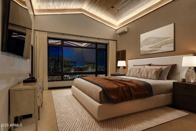 a living room with couches a fireplace and a dining table with wooden floor