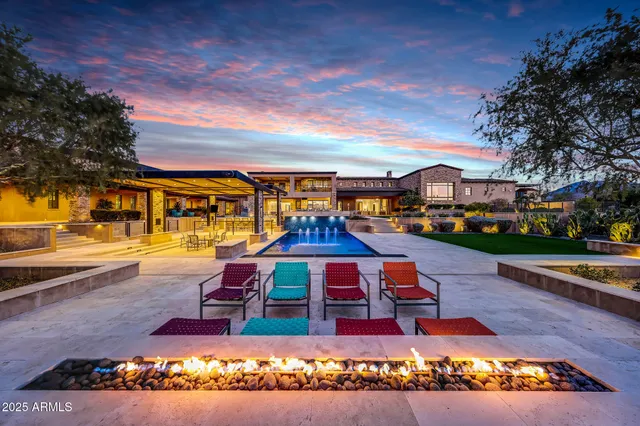 a large white kitchen with stainless steel appliances kitchen island granite countertop a refrigerator and a stove top oven