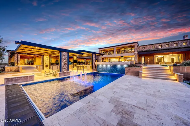 a view of a house with a yard and potted plants