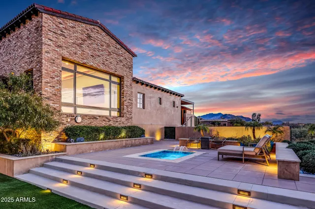 a spacious bedroom with a bed a table and painting