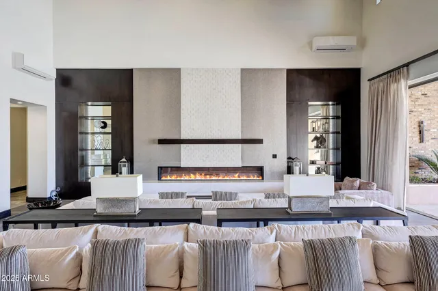 a living room with furniture and a chandelier