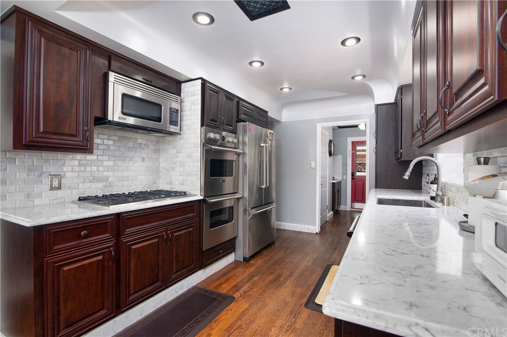 431 Monte Vista Road Arcadia, CA 91007 - Photo 13 of 30 a kitchen with stainless steel appliances granite countertop a stove refrigerator and microwave