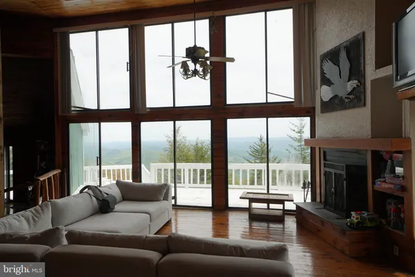 a living room with furniture and a floor to ceiling window