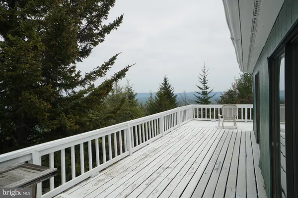 a view of a balcony with wooden floor and fence