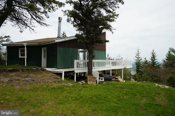 a view of balcony with wooden floor and fence
