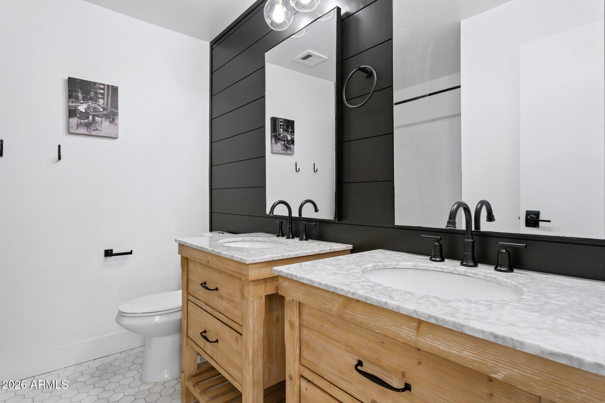 1715 West Orchid Lane Phoenix, AZ 85021 - Photo 7 of 57 a bathroom with a granite countertop sink and a mirror