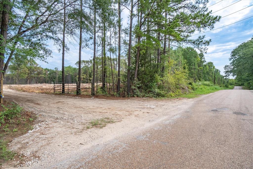 4307 Rd Larue Tx 75770 Road Larue, TX 75770 - Photo 2 of 17 Gravel road frontage with a metal gate entrance leading to a partially cleared lot