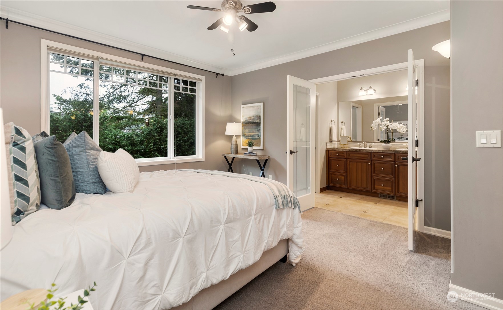 8507 Bowdoin Way, Unit 2 Edmonds, WA 98026 - Photo 14 of 24 a spacious bedroom with a large bed and a chandelier