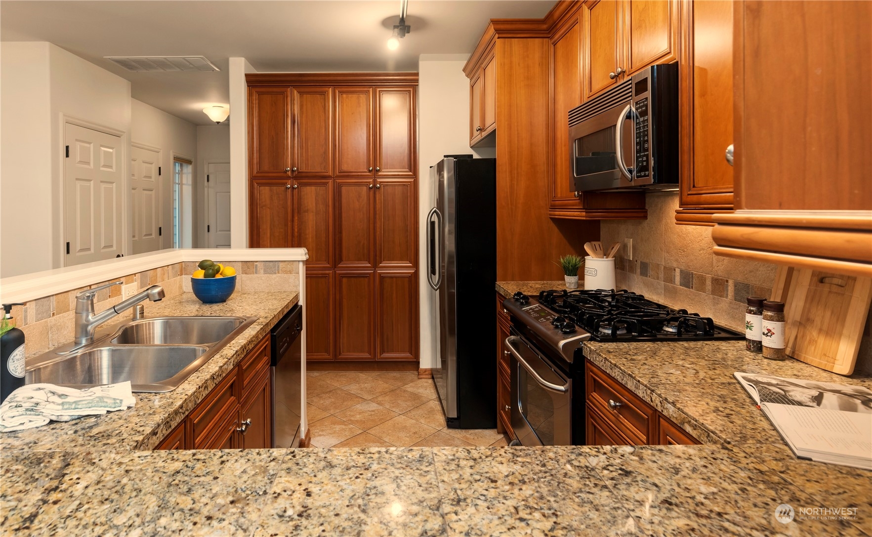 8507 Bowdoin Way, Unit 2 Edmonds, WA 98026 - Photo 9 of 24 a kitchen with a refrigerator stove and sink