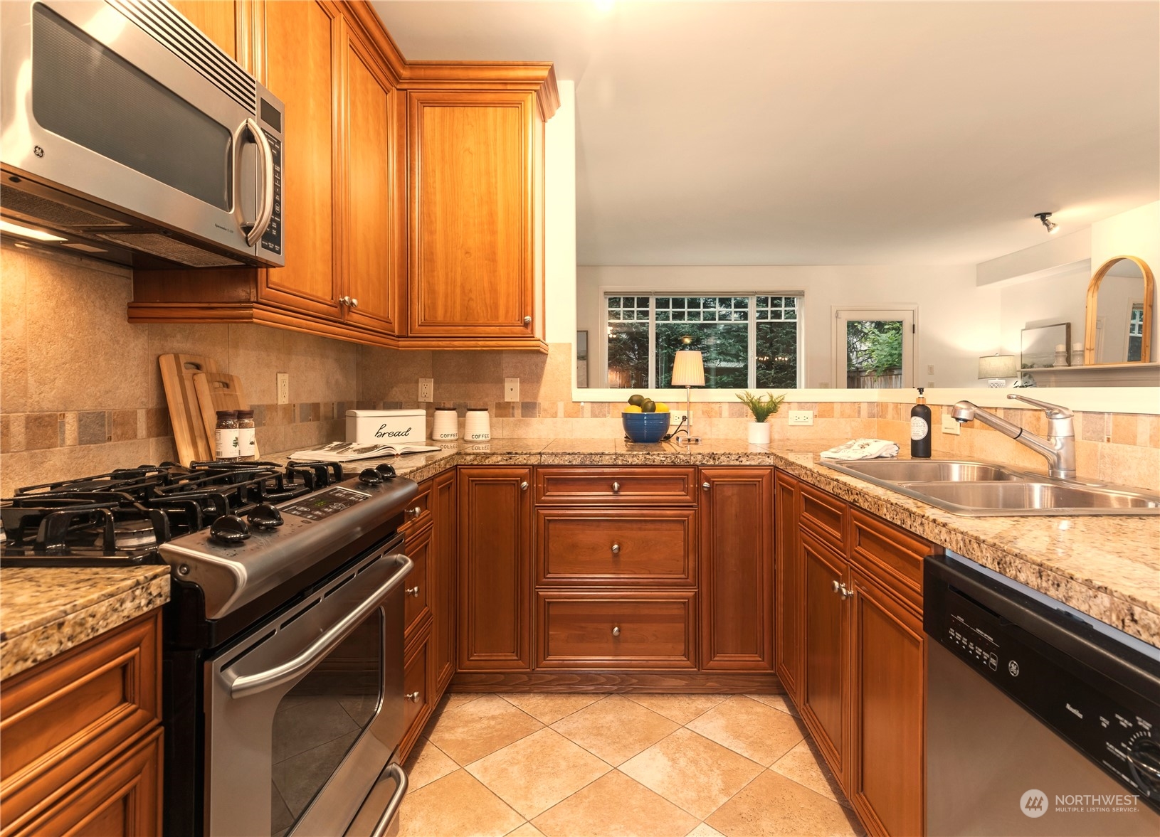 8507 Bowdoin Way, Unit 2 Edmonds, WA 98026 - Photo 10 of 24 a kitchen with a sink stove top oven and cabinets