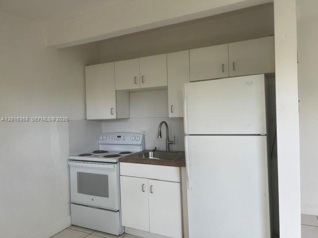 441 Southwest 10th Street, Unit 4 Miami, FL 33130 - Photo 15 of 18 a kitchen with refrigerator a stove a sink and cabinets
