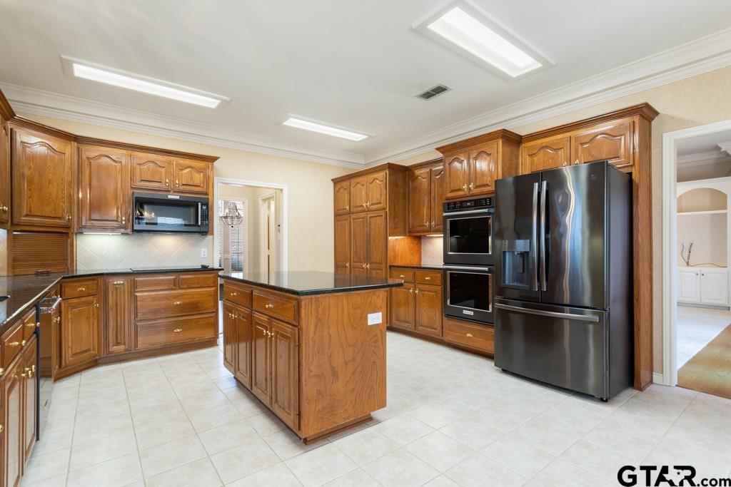 3103 Lakepine Circle Tyler, TX 75707 - Photo 14 of 48 a kitchen with stainless steel appliances granite countertop a refrigerator and a stove