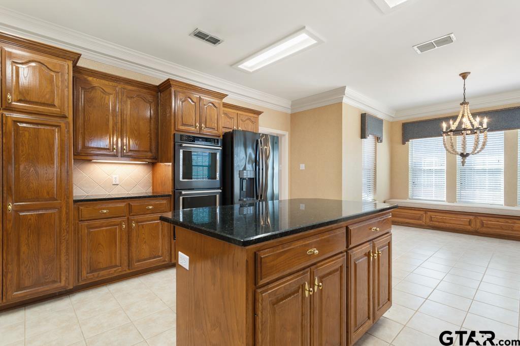 3103 Lakepine Circle Tyler, TX 75707 - Photo 17 of 48 a kitchen with stainless steel appliances granite countertop a refrigerator a stove and a sink with cabinets