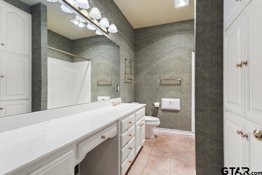 3103 Lakepine Circle Tyler, TX 75707 - Photo 36 of 48 a bathroom with a sink a toilet and a mirror