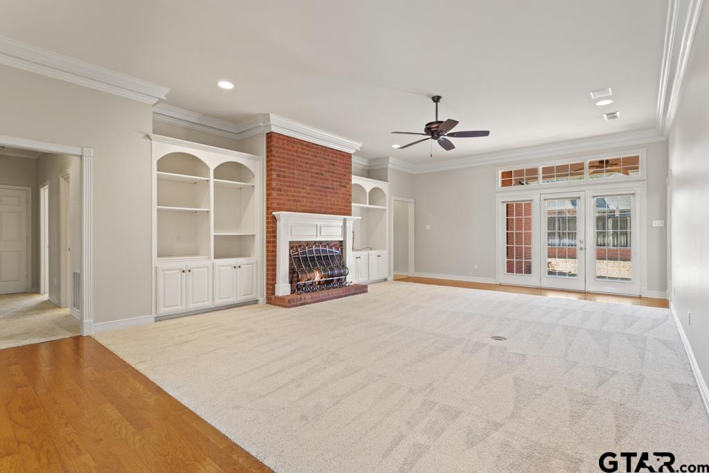 3103 Lakepine Circle Tyler, TX 75707 - Photo 5 of 48 an empty room with windows and a fireplace