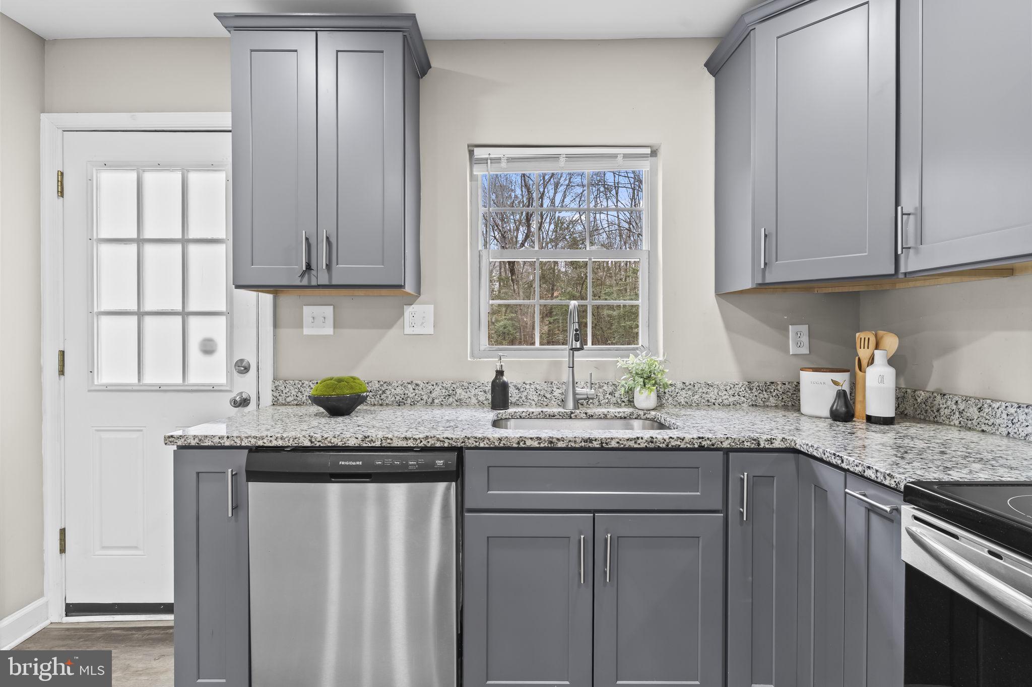 38461 Chaptico Road Mechanicsville, MD 20659 - Photo 7 of 35 a kitchen with granite countertop stainless steel appliances white cabinets sink and window