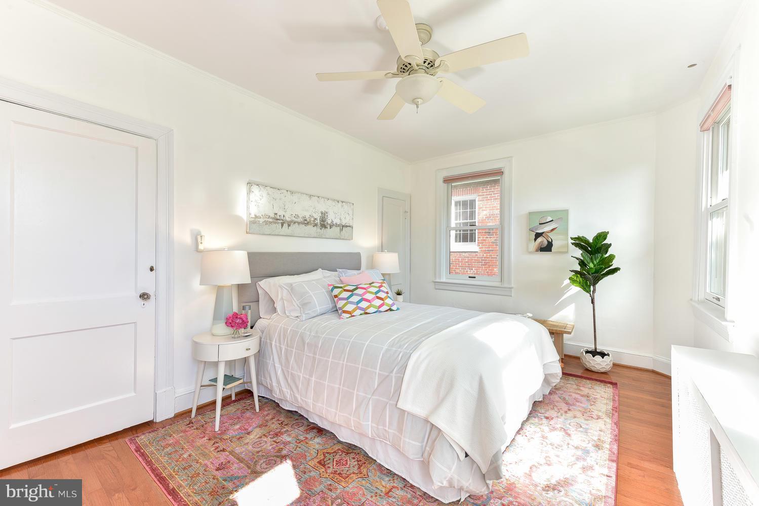 4427 Garrison Street Northwest Washington, DC 20016 - Photo 15 of 27 a bedroom with a bed and a chandelier