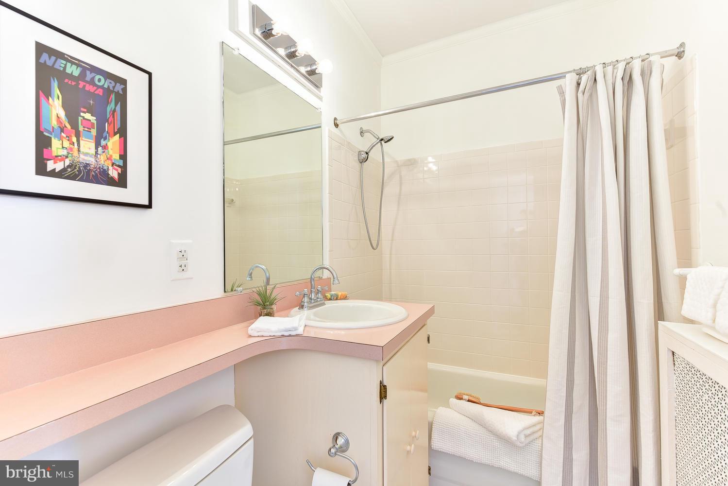 4427 Garrison Street Northwest Washington, DC 20016 - Photo 16 of 27 a bathroom with a sink a mirror and a shower