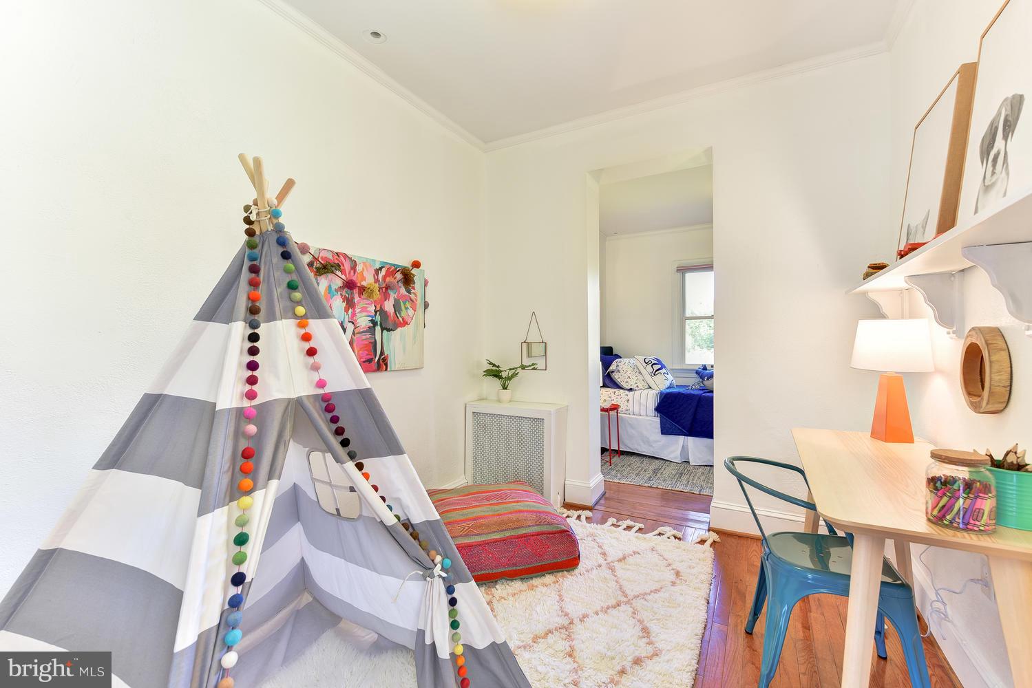 4427 Garrison Street Northwest Washington, DC 20016 - Photo 17 of 27 a bed room with a bed and a couch