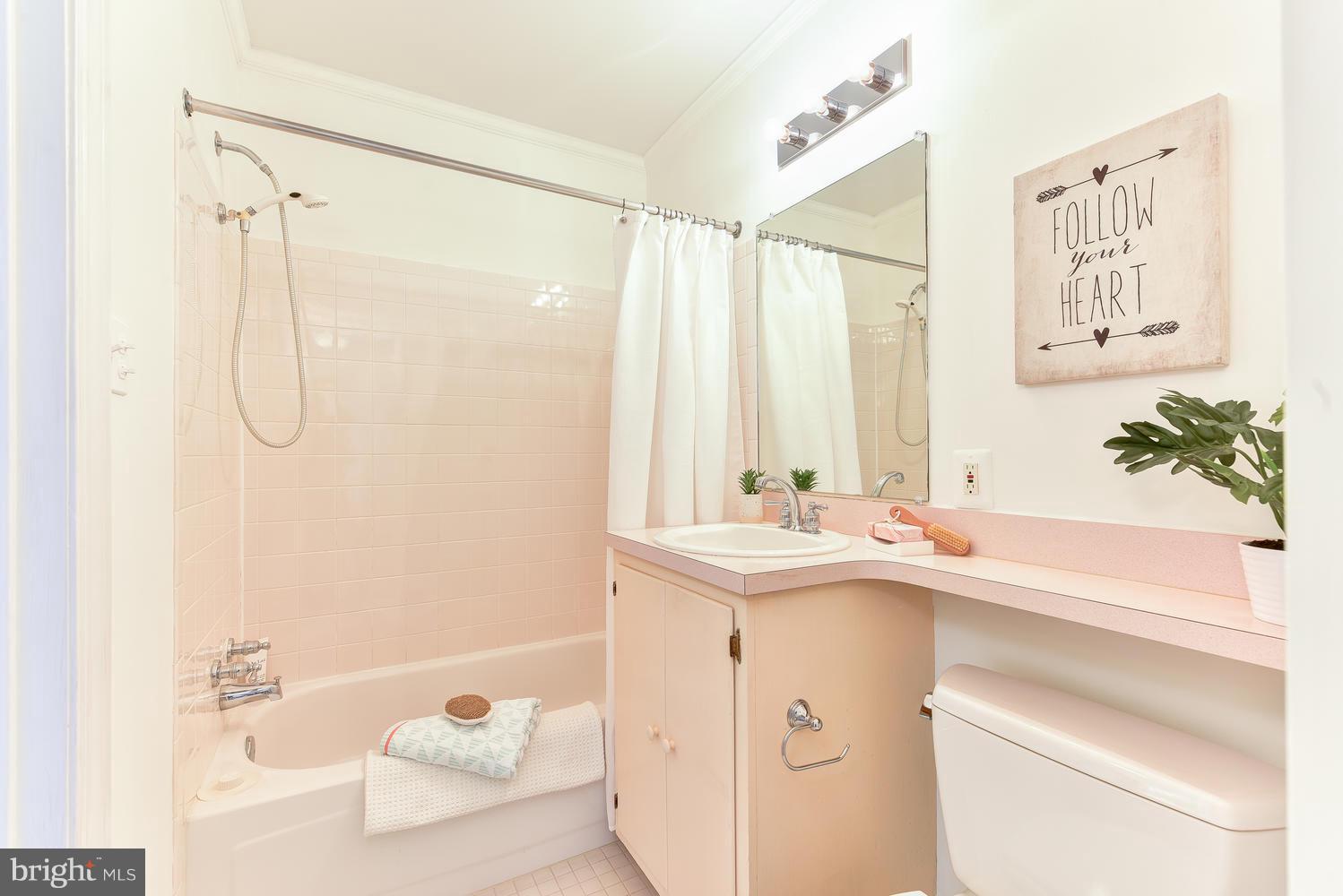 4427 Garrison Street Northwest Washington, DC 20016 - Photo 19 of 27 a bathroom with a sink a large mirror and a shower