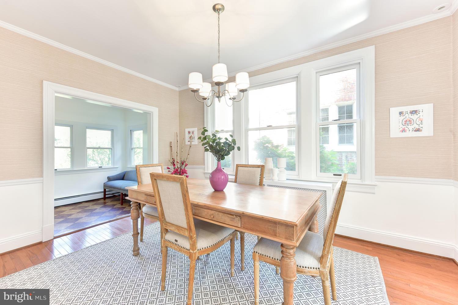 4427 Garrison Street Northwest Washington, DC 20016 - Photo 7 of 27 a dining room with furniture a chandelier and wooden floor