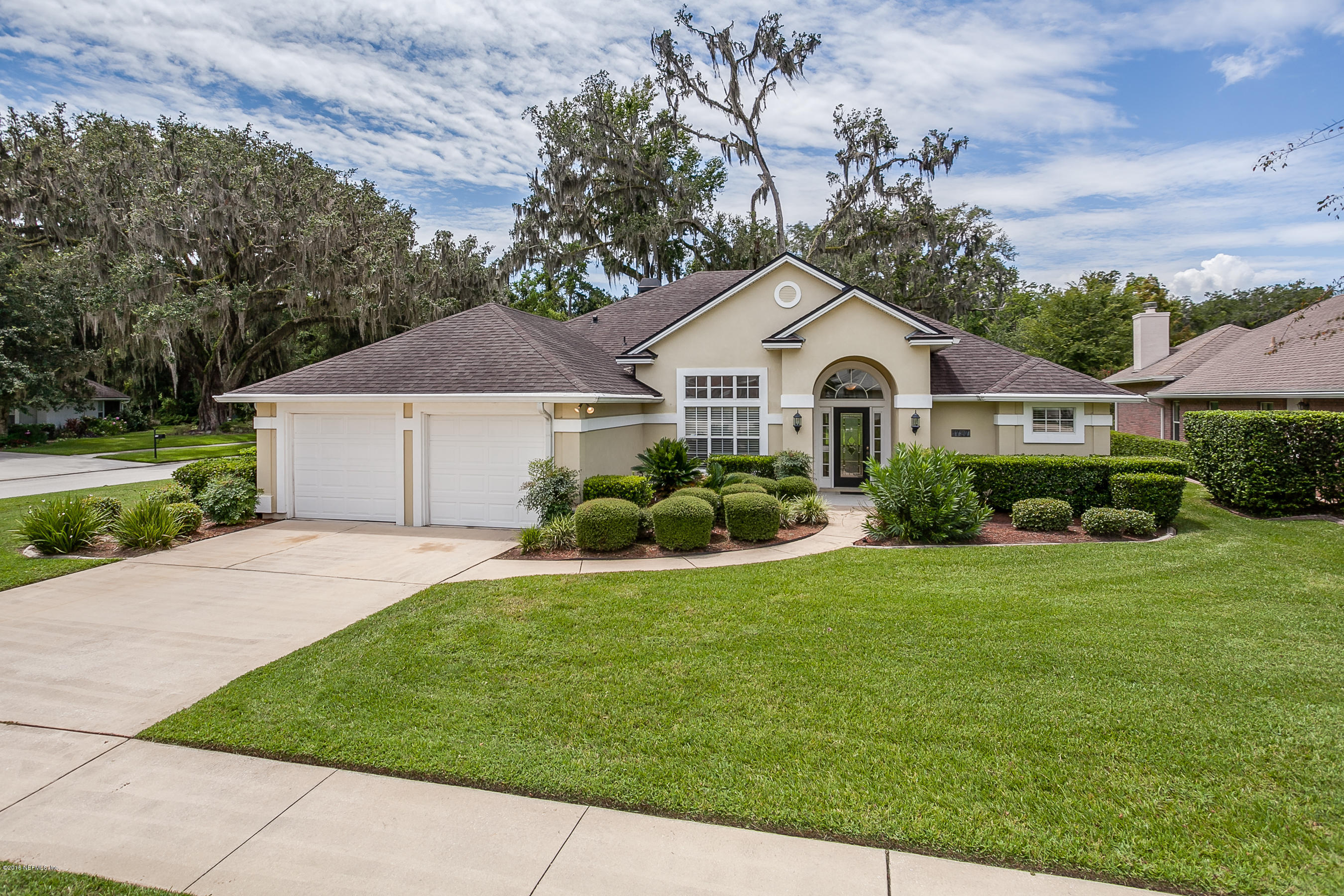 1727 Margarets Walk Road Fleming Island, FL 32003 - Photo 1 of 53 a front view of a house with a garden and yard