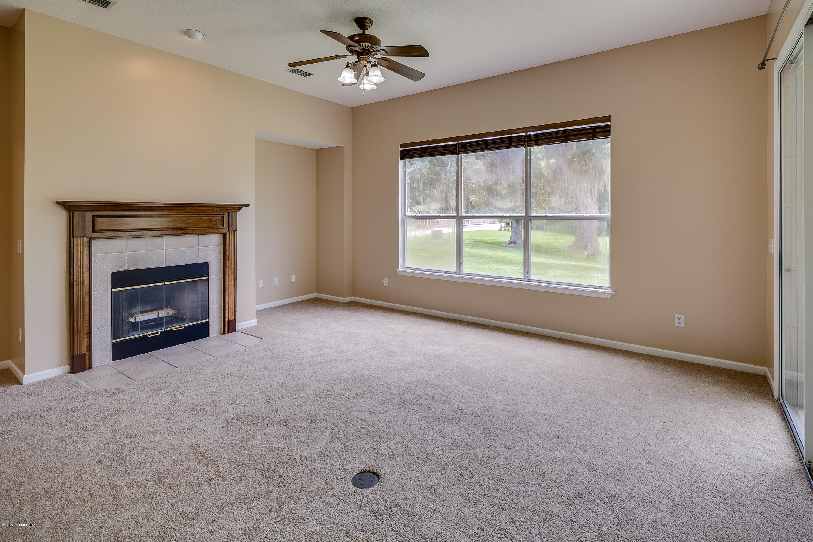 1727 Margarets Walk Road Fleming Island, FL 32003 - Photo 11 of 53 an empty room with windows and fireplace