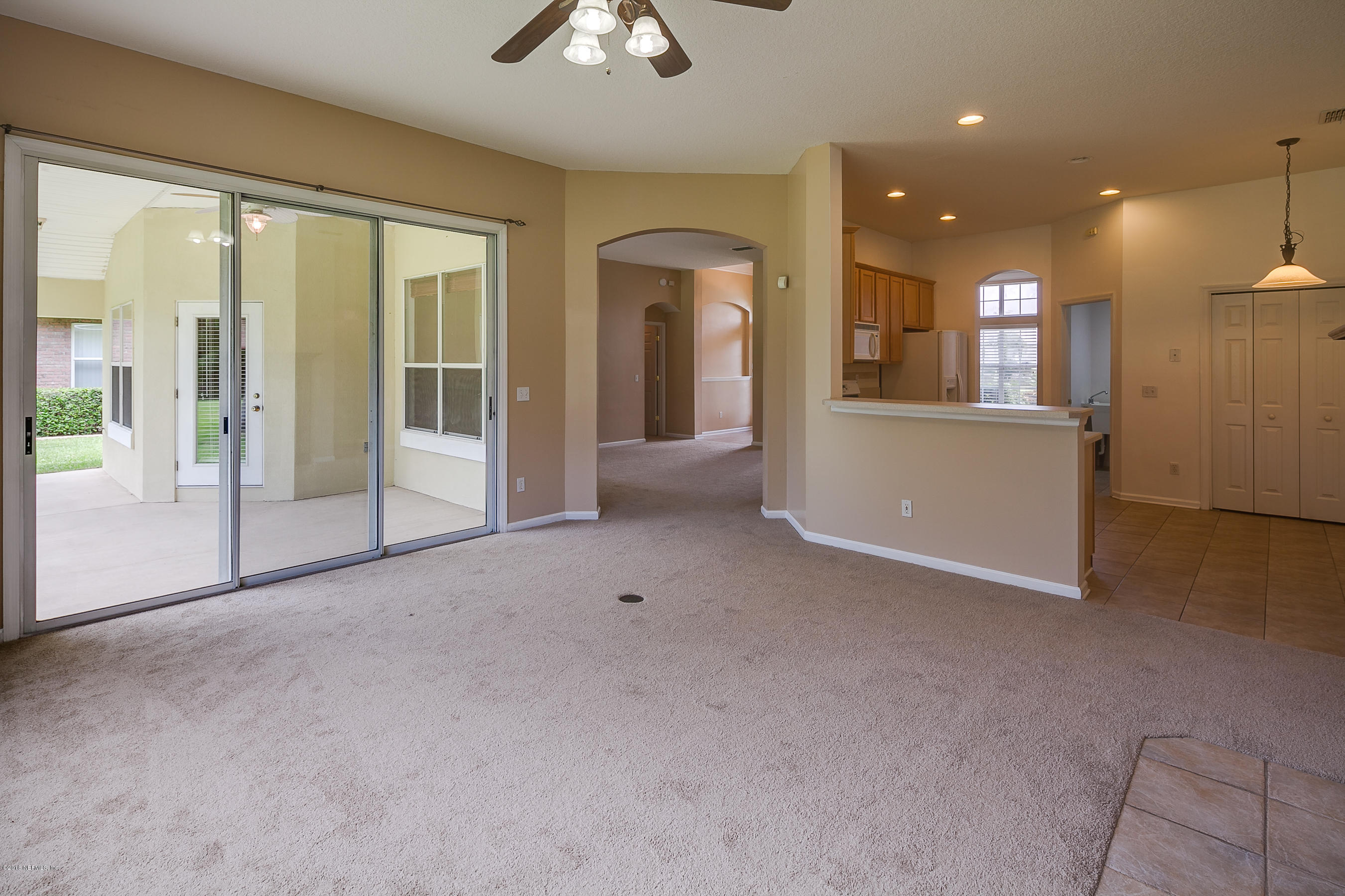 1727 Margarets Walk Road Fleming Island, FL 32003 - Photo 13 of 53 a view of a big room with windows and chandelier