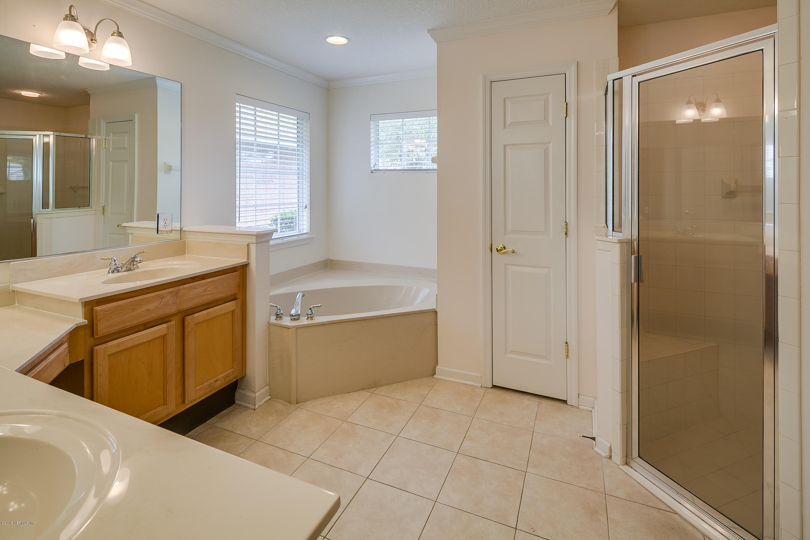 1727 Margarets Walk Road Fleming Island, FL 32003 - Photo 16 of 53 a bathroom with a tub sink and mirror