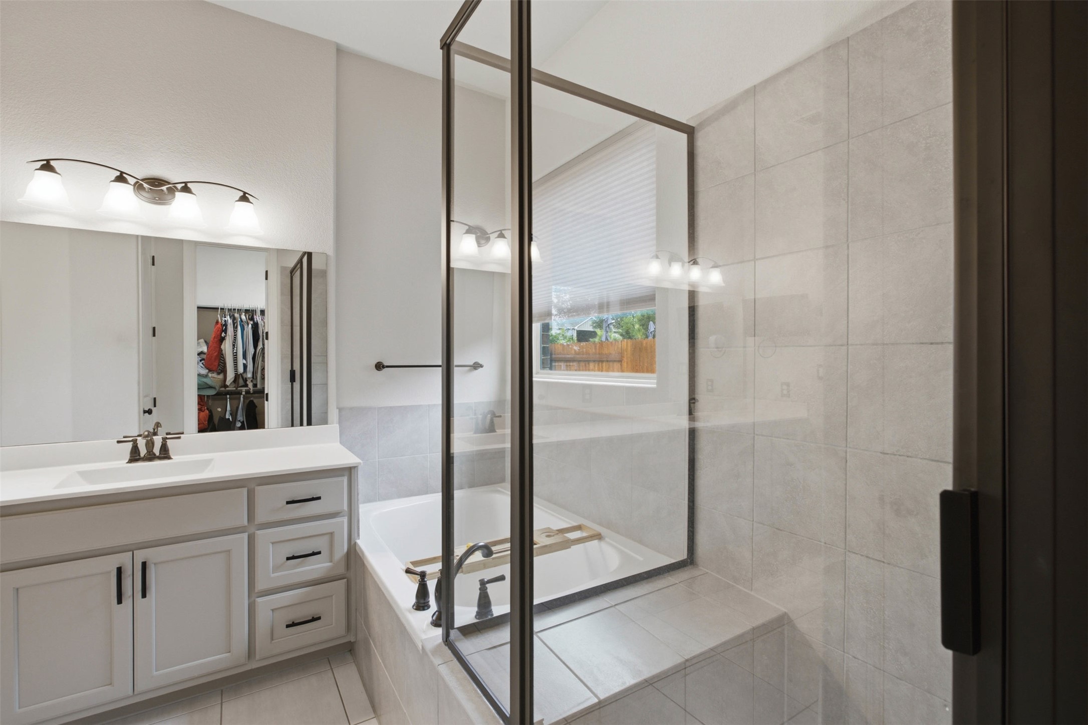 1113 Modoc Way Kyle, TX 78640 - Photo 20 of 34 Luxurious soaking tub and tiled shower with contemporary glass enclosure.