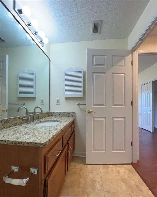 1800 Clairmont Lake, Unit 711 Decatur, GA 30033 - Photo 21 of 40 a bathroom with a granite countertop sink and a mirror