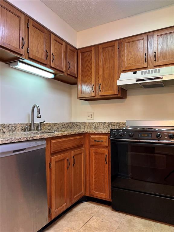 1800 Clairmont Lake, Unit 711 Decatur, GA 30033 - Photo 7 of 40 a kitchen with stainless steel appliances granite countertop a stove and a sink