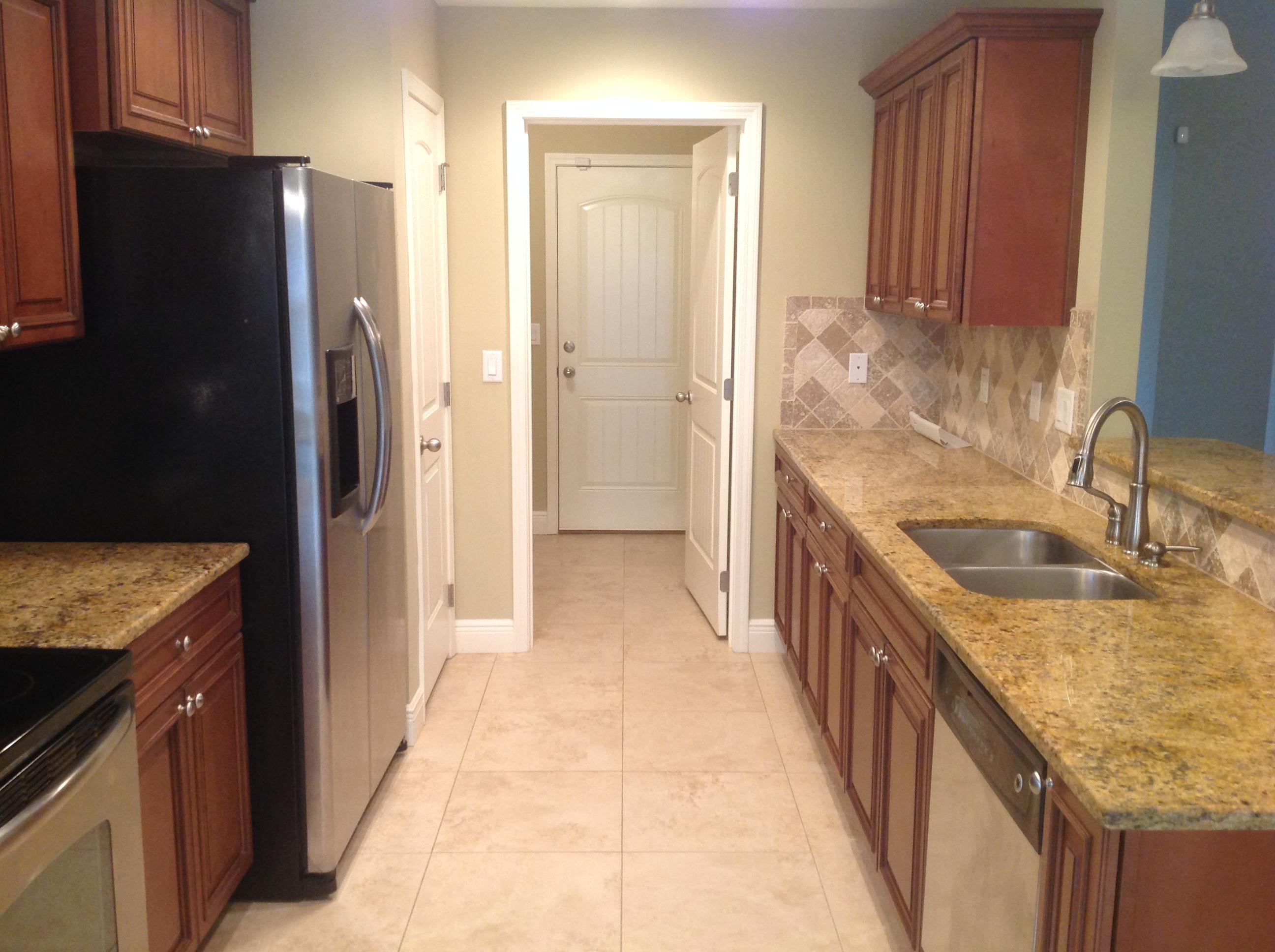 227 January Court Crestview, FL 32539 - Photo 8 of 20 a kitchen with granite countertop a refrigerator and a sink