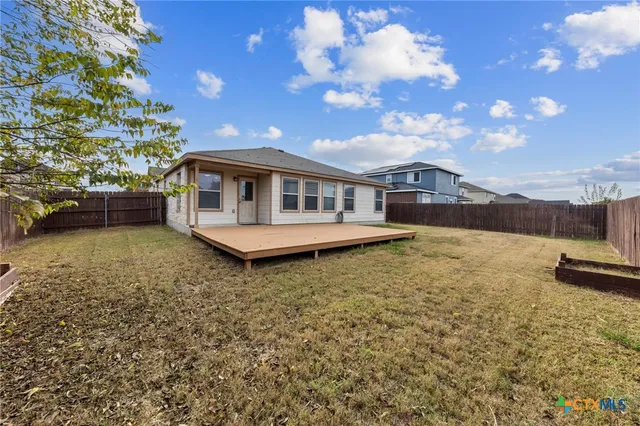 a front view of a house with a garden and yard