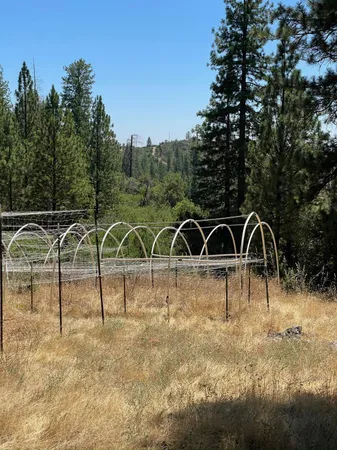 a view of a wooden fence with a yard