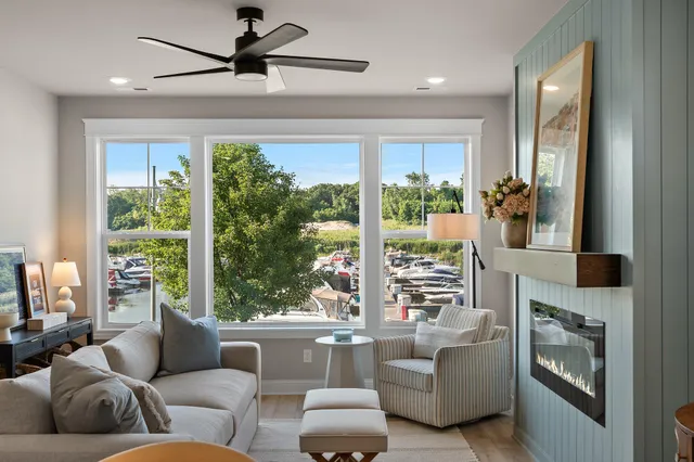 a living room with furniture fireplace and a large window