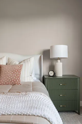 a bedroom with a bed and a lamp