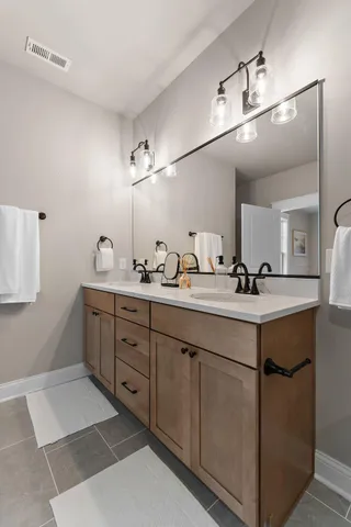 a spacious bathroom with a double vanity sink and a mirror