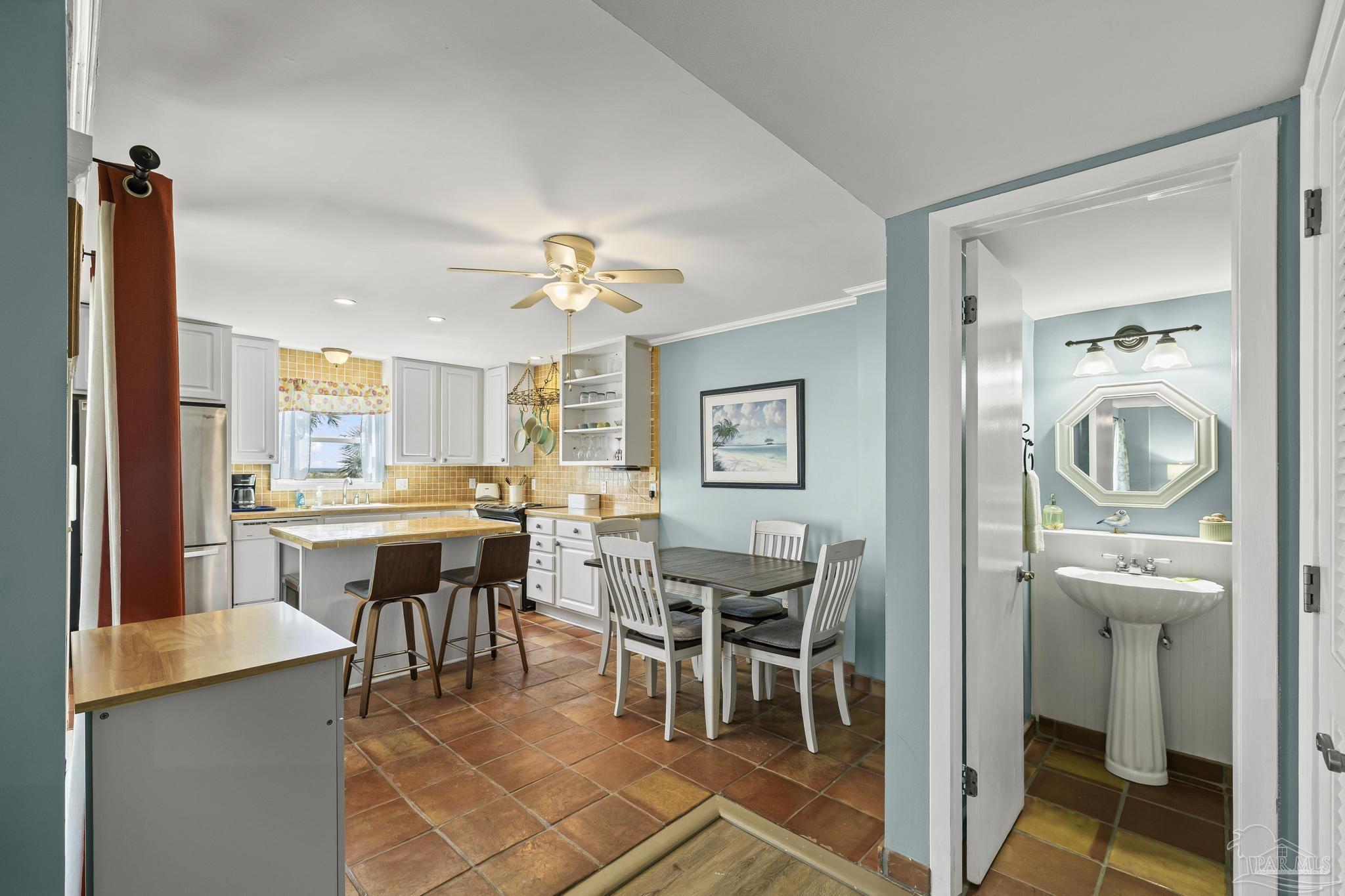1100 Fort Pickens Road, Unit A13 Pensacola Beach, FL 32561 - Photo 17 of 63 a view of a dining room with furniture and chandelier