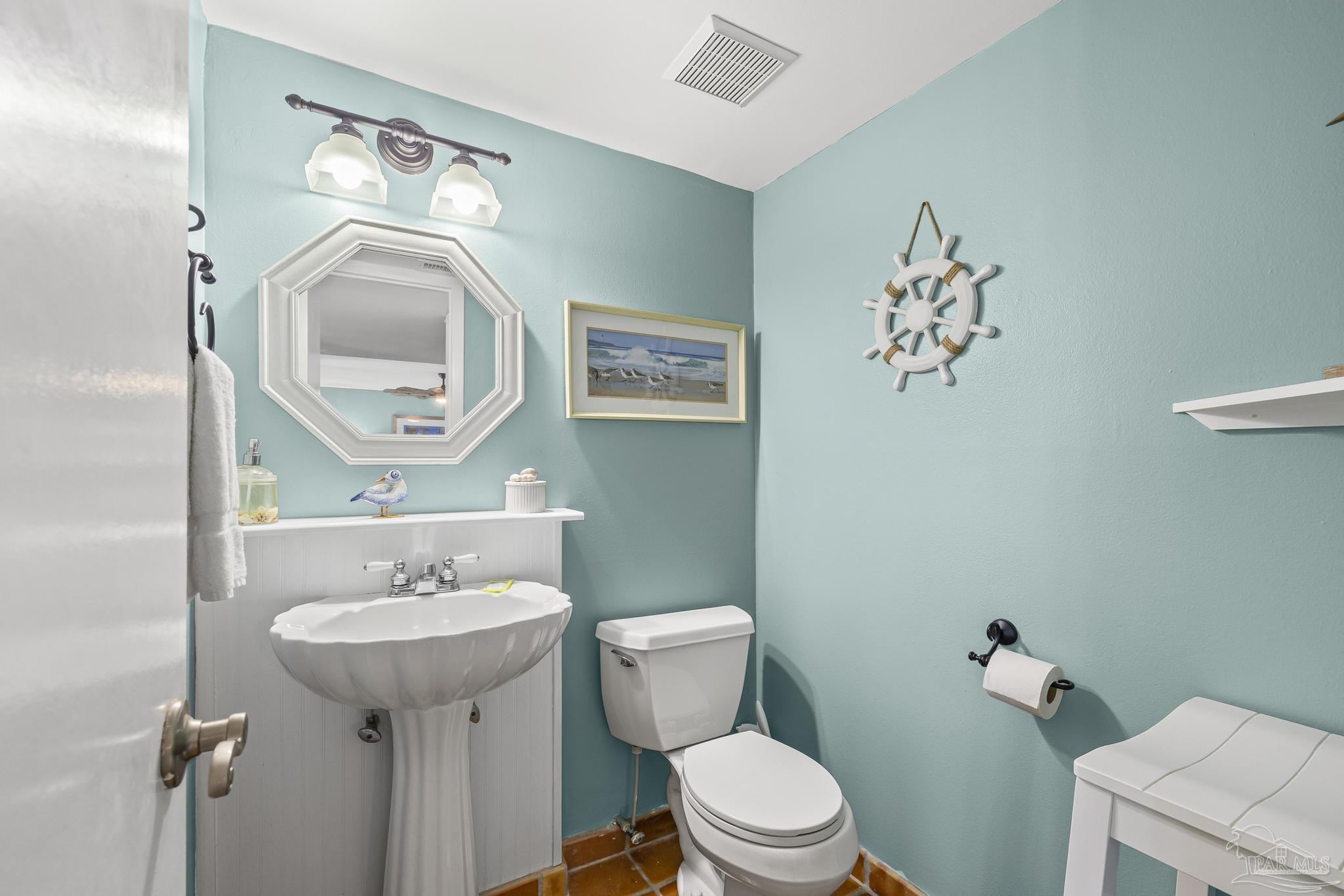 1100 Fort Pickens Road, Unit A13 Pensacola Beach, FL 32561 - Photo 18 of 63 a bathroom with a toilet sink and mirror