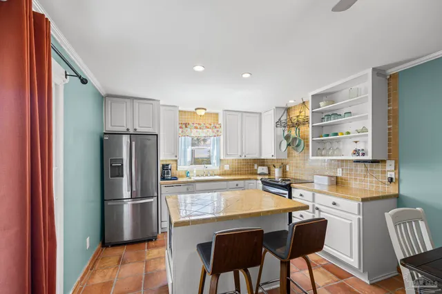 a kitchen with stainless steel appliances a stove a sink and a microwave