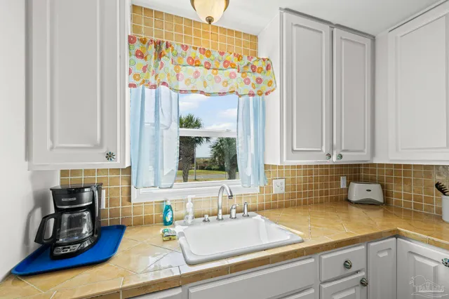 a kitchen with stainless steel appliances a sink a stove a refrigerator and cabinets