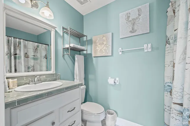 a spacious bedroom with a bed and a chair