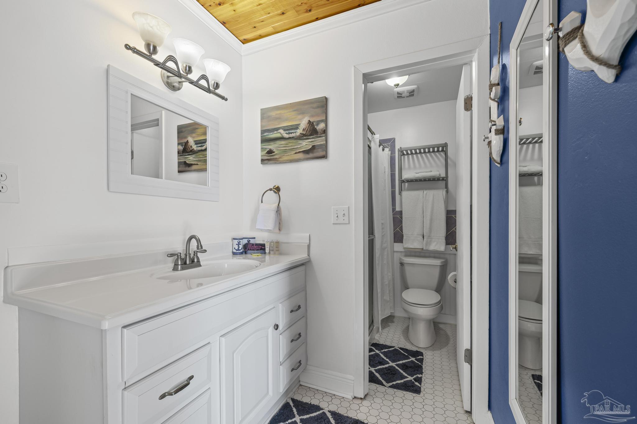 1100 Fort Pickens Road, Unit A13 Pensacola Beach, FL 32561 - Photo 32 of 63 a bathroom with a sink a vanity and a mirror
