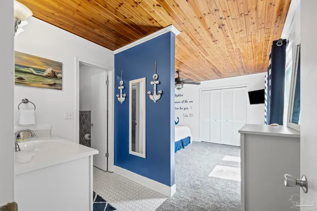 a view of a patio with couches plants and wooden floor